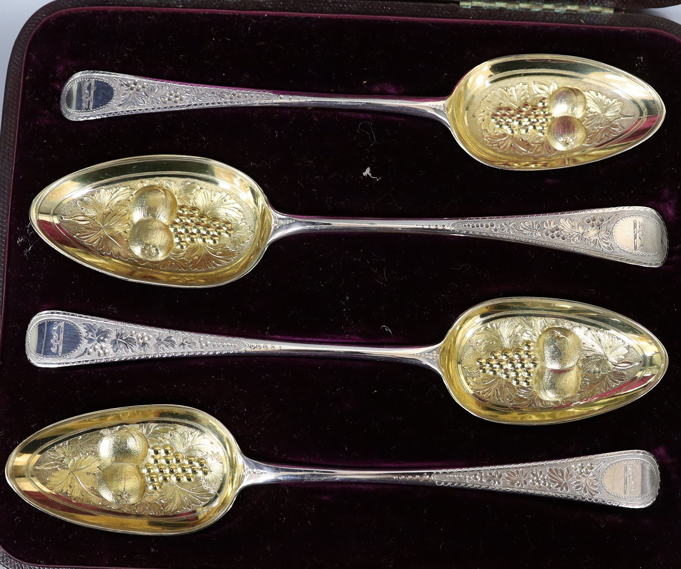 A cased matched set of four 19th century parcel gilt berry spoons, 7.5oz